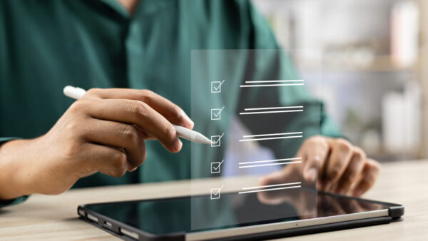 A marketer using Dotdigital’s email service provider (ESP) migration checklist on iPad, planning a smooth transition to the new platform.